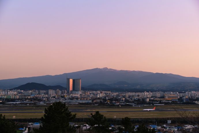 View over Jeju Airport to Jeju City and Mt Hallasan on Jeju Island